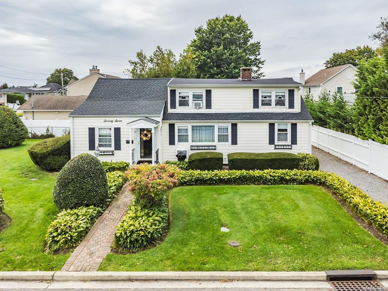 77 Beverly Road Massapequa, NY 11758 - Photo 1 of 1 a front view of a house with garden