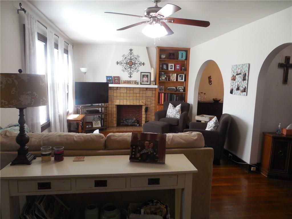1435 Ridge Avenue Coraopolis, PA 15108 - Photo 5 of 24 The living room is bright and cheery. Note the amazing hardwood floors and arched entries to the dining room and staircase. A great combination of modern and by-gone eras throughout the home.