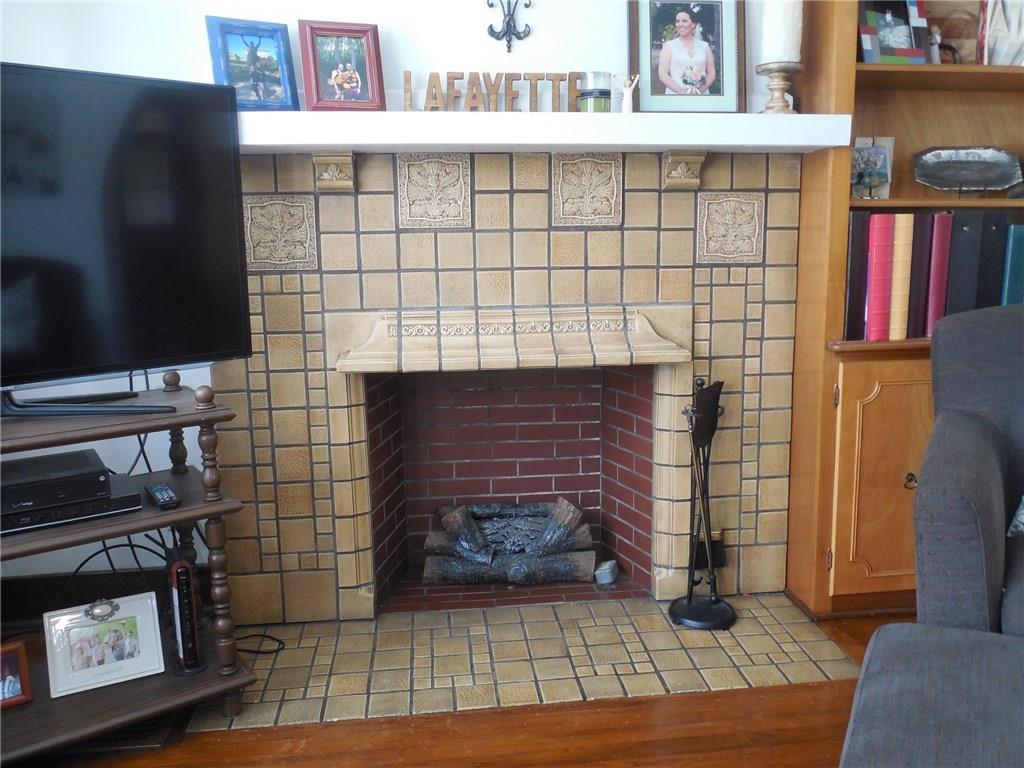 1435 Ridge Avenue Coraopolis, PA 15108 - Photo 6 of 24 The decorative fireplace sports electric logs and beautiful craftsmanship.