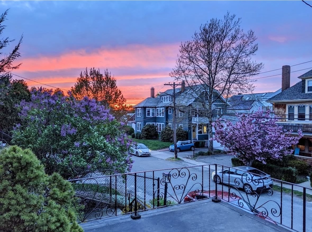 a view of a house with a wooden fence