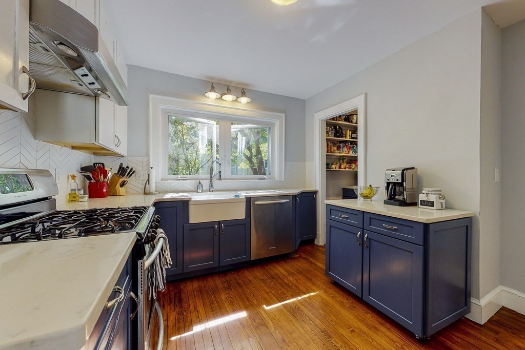 15 Sunset Road, Unit 15 Watertown, MA 02472 - Photo 7 of 22 a kitchen with stainless steel appliances granite countertop a stove a sink dishwasher and cabinets with wooden floor