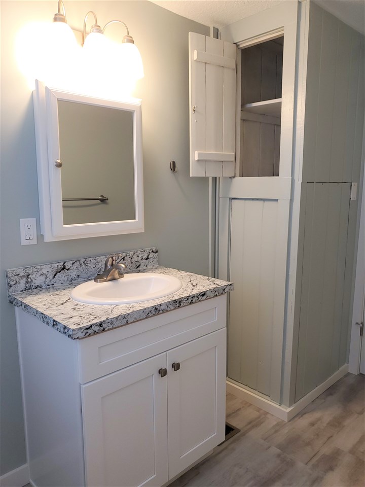 105 Beachcomber Way, Unit B St. Augustine, FL 32084 - Photo 11 of 14 a bathroom with a granite countertop sink and a mirror