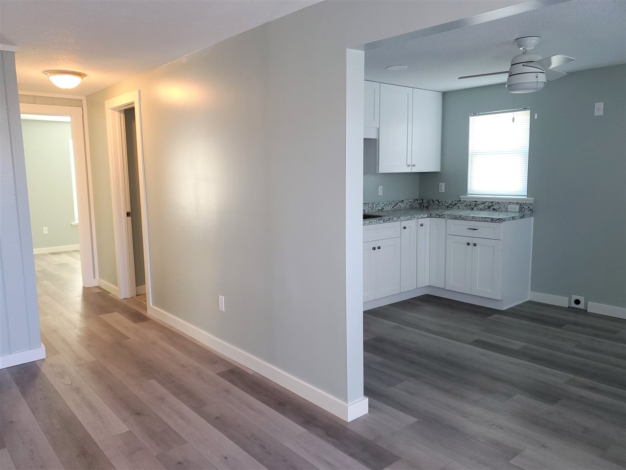 105 Beachcomber Way, Unit B St. Augustine, FL 32084 - Photo 4 of 14 a bathroom with granite countertop a sink and a mirror