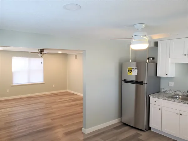 a view of a kitchen cabinets and wooden floor