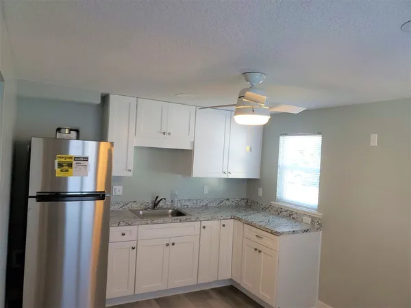 a kitchen with a refrigerator and window