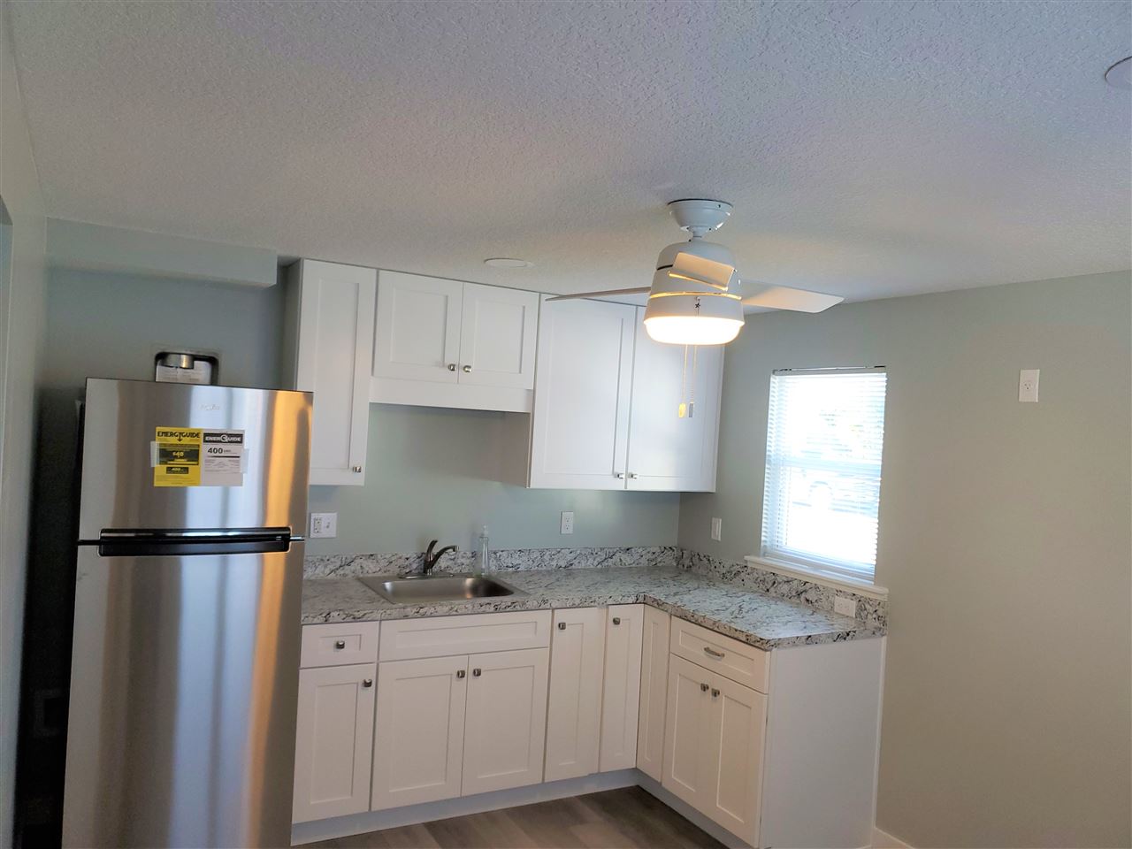105 Beachcomber Way, Unit B St. Augustine, FL 32084 - Photo 7 of 14 a kitchen with a refrigerator and window