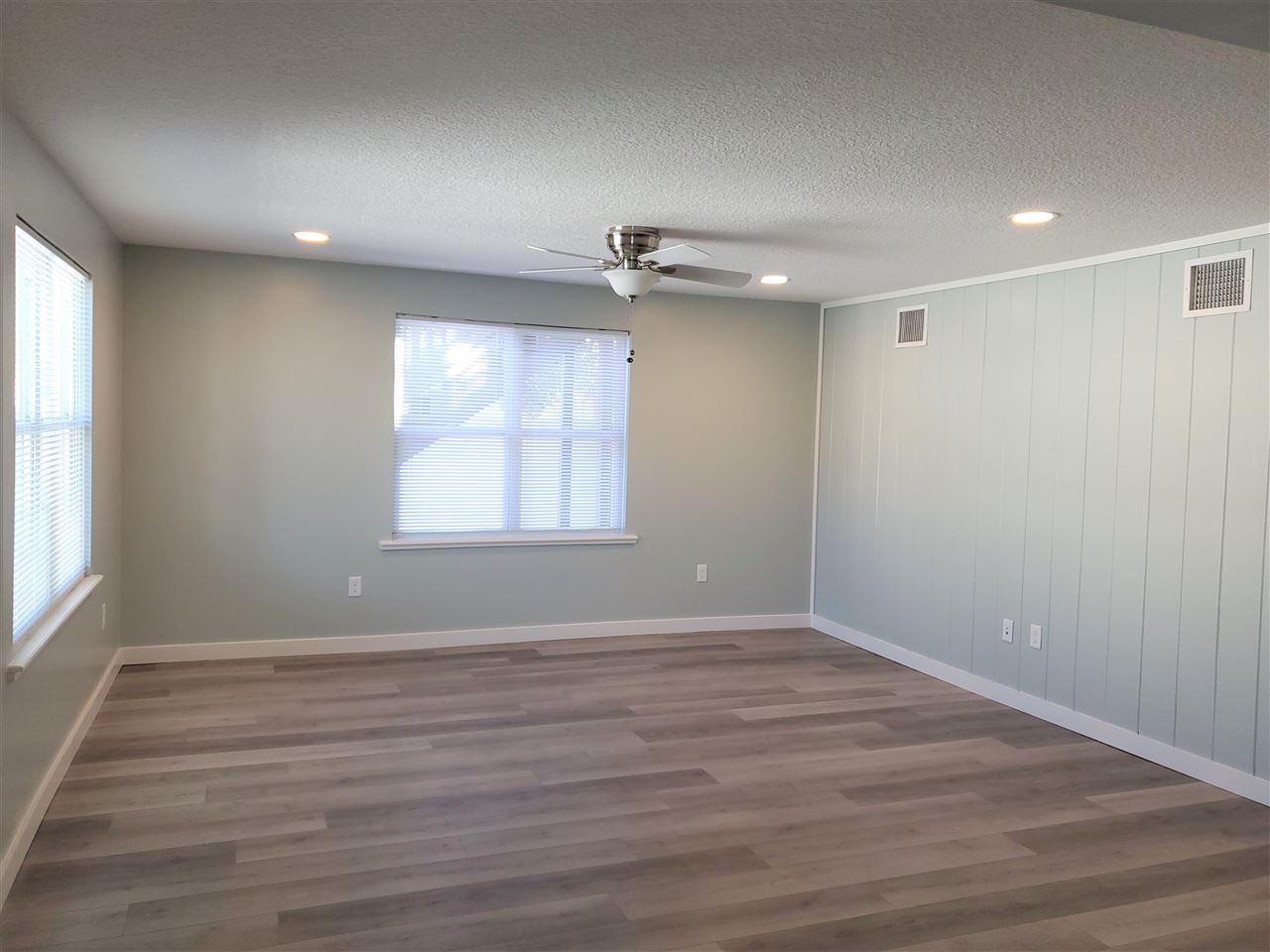 105 Beachcomber Way, Unit B St. Augustine, FL 32084 - Photo 8 of 14 an empty room with wooden floor and windows