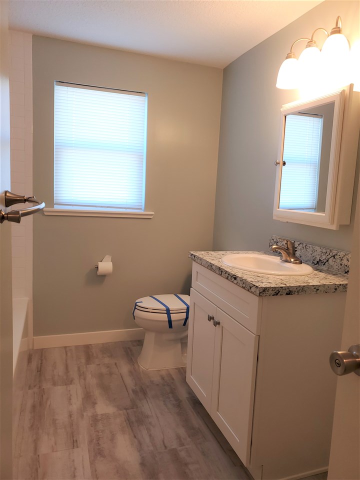 105 Beachcomber Way, Unit B St. Augustine, FL 32084 - Photo 9 of 14 a bathroom with a sink a toilet and a mirror