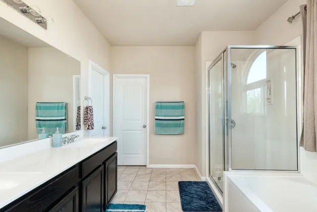 a bathroom with a tub shower and sink