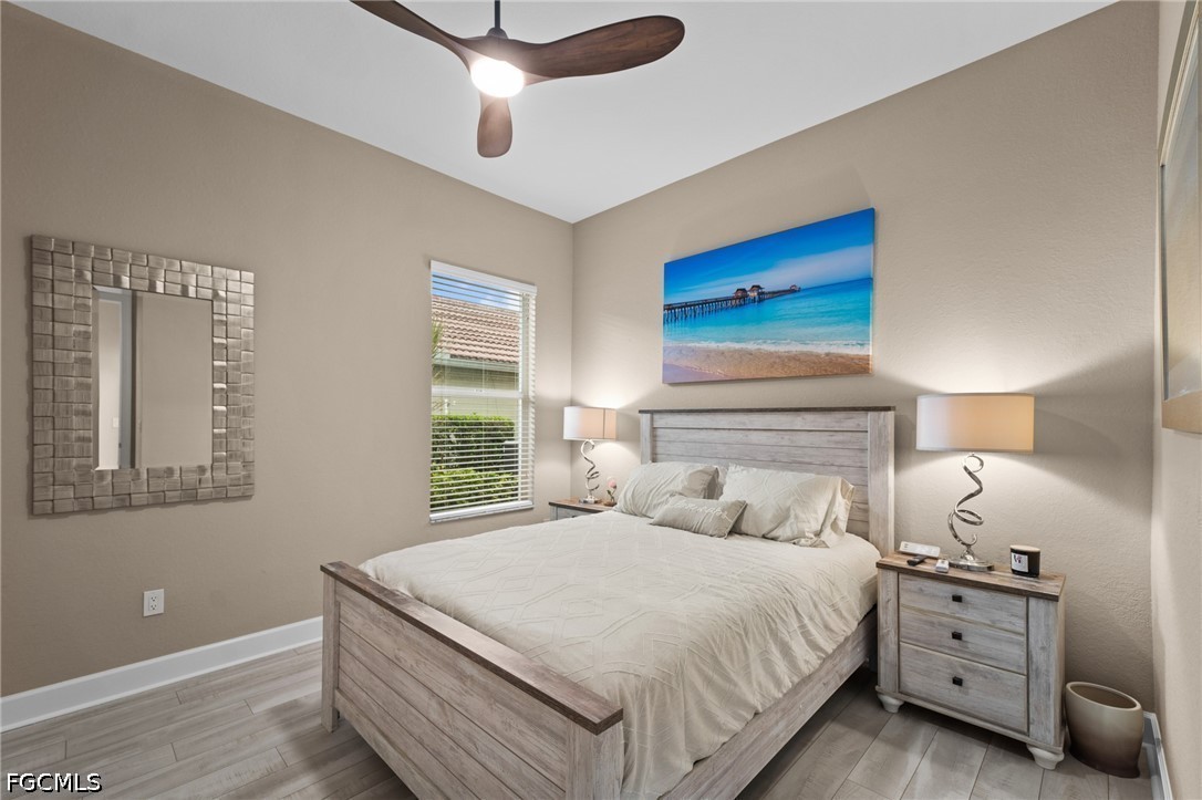 9042 Bronco Court Naples, FL 34113 - Photo 21 of 50 a bedroom with bed and window