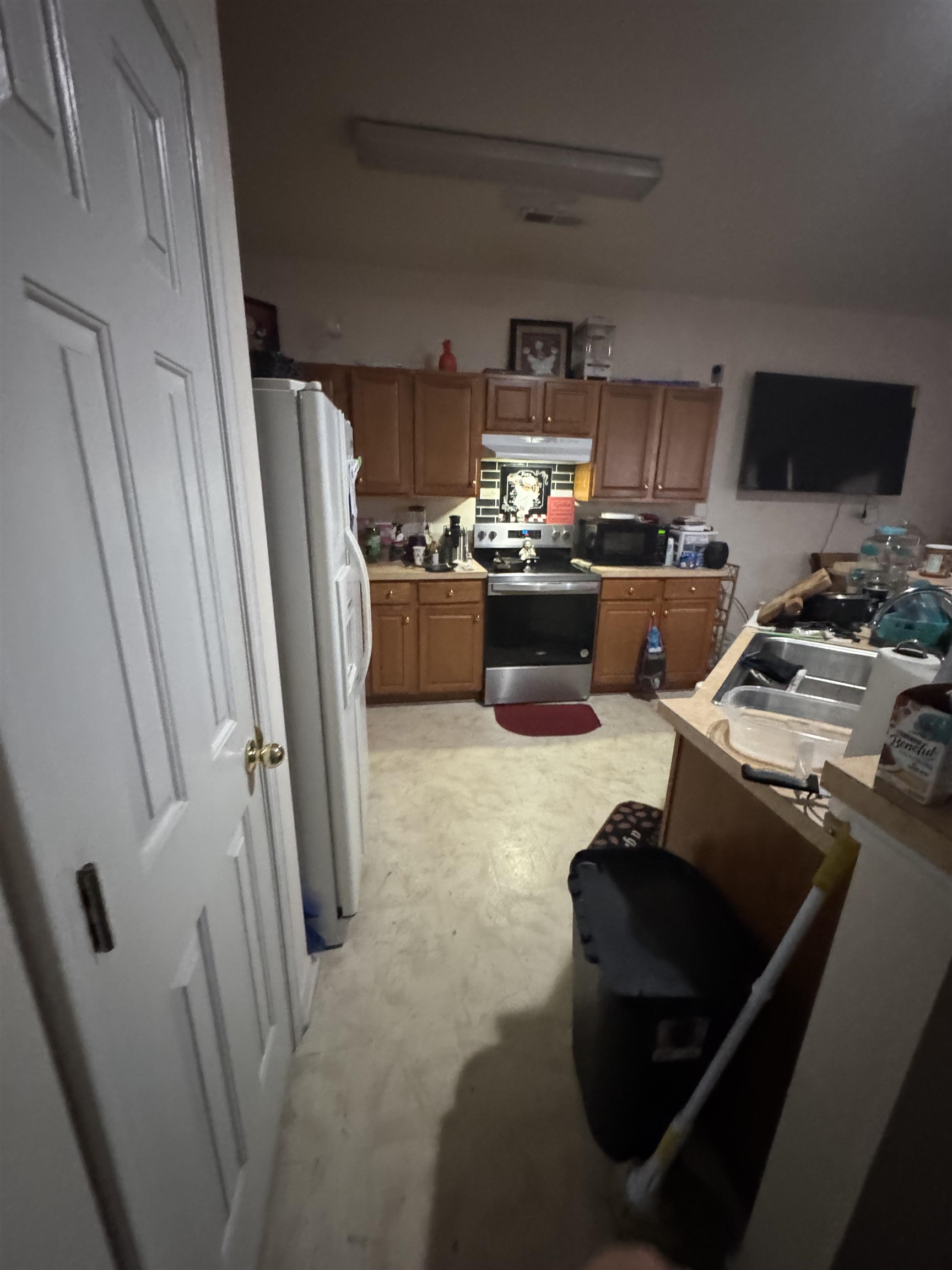 116 Olde Towne Way, Unit 6 Myrtle Beach, SC 29588 - Photo 8 of 23 Kitchen with electric stove, light countertops, white fridge with ice dispenser, brown cabinetry, and under cabinet range hood