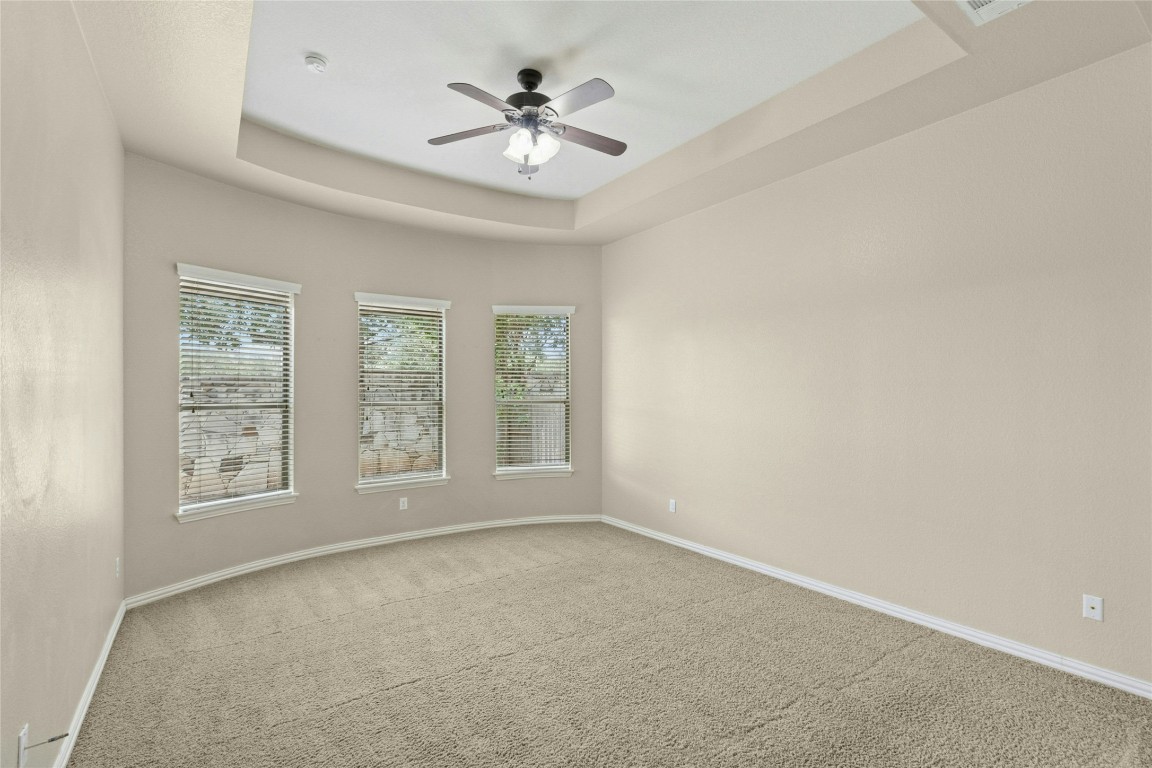 2804 Prosperity Leander, TX 78641 - Photo 16 of 39 Carpeted spare room with ceiling fan, baseboards, healthy amount of natural light, and a tray ceiling