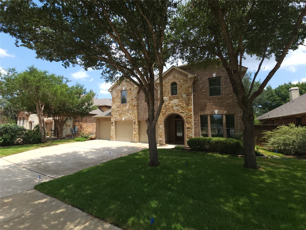 2804 Prosperity Leander, TX 78641 - Photo 2 of 39 View of front facade with a front yard, concrete driveway, an attached garage, stone siding, and brick siding