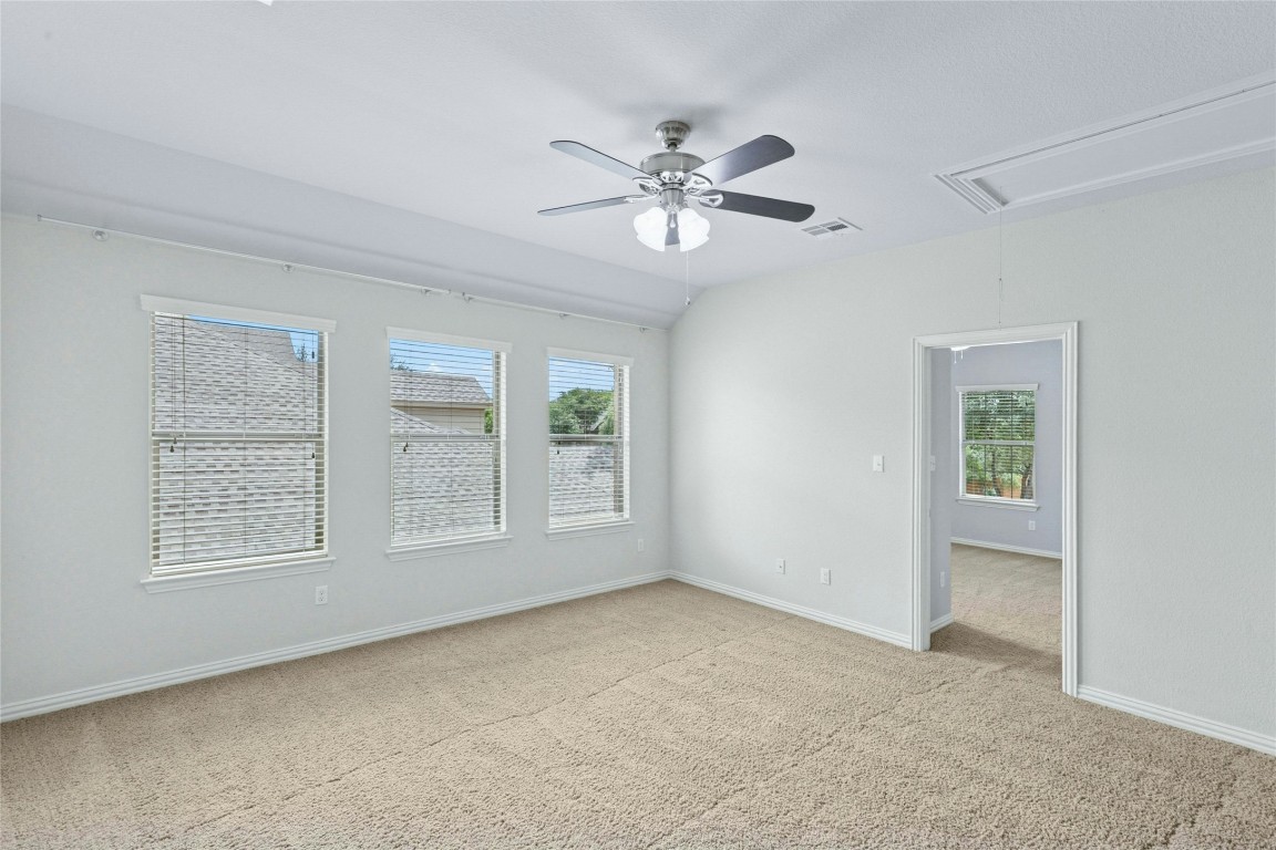 2804 Prosperity Leander, TX 78641 - Photo 22 of 39 Empty room featuring attic access, light colored carpet, ceiling fan, and healthy amount of natural light