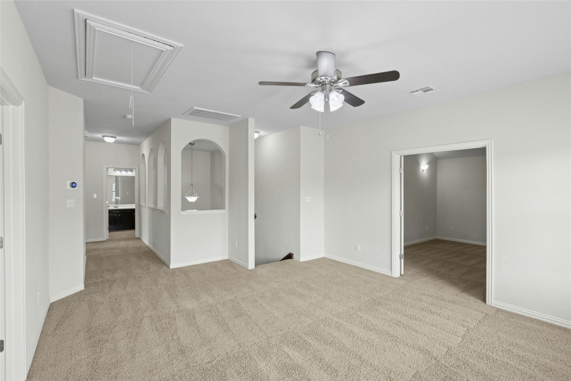 2804 Prosperity Leander, TX 78641 - Photo 24 of 39 Empty room featuring attic access, carpet, a ceiling fan, and baseboards