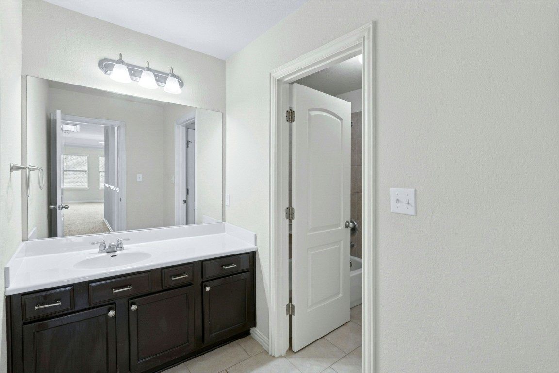2804 Prosperity Leander, TX 78641 - Photo 33 of 39 Full bathroom with vanity, tile patterned flooring, and shower combination