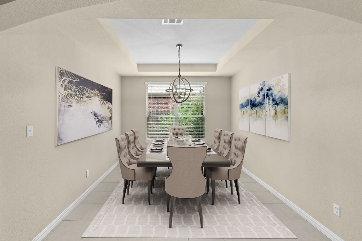2804 Prosperity Leander, TX 78641 - Photo 5 of 39 Dining space featuring a raised ceiling, a chandelier, and light tile patterned floors
