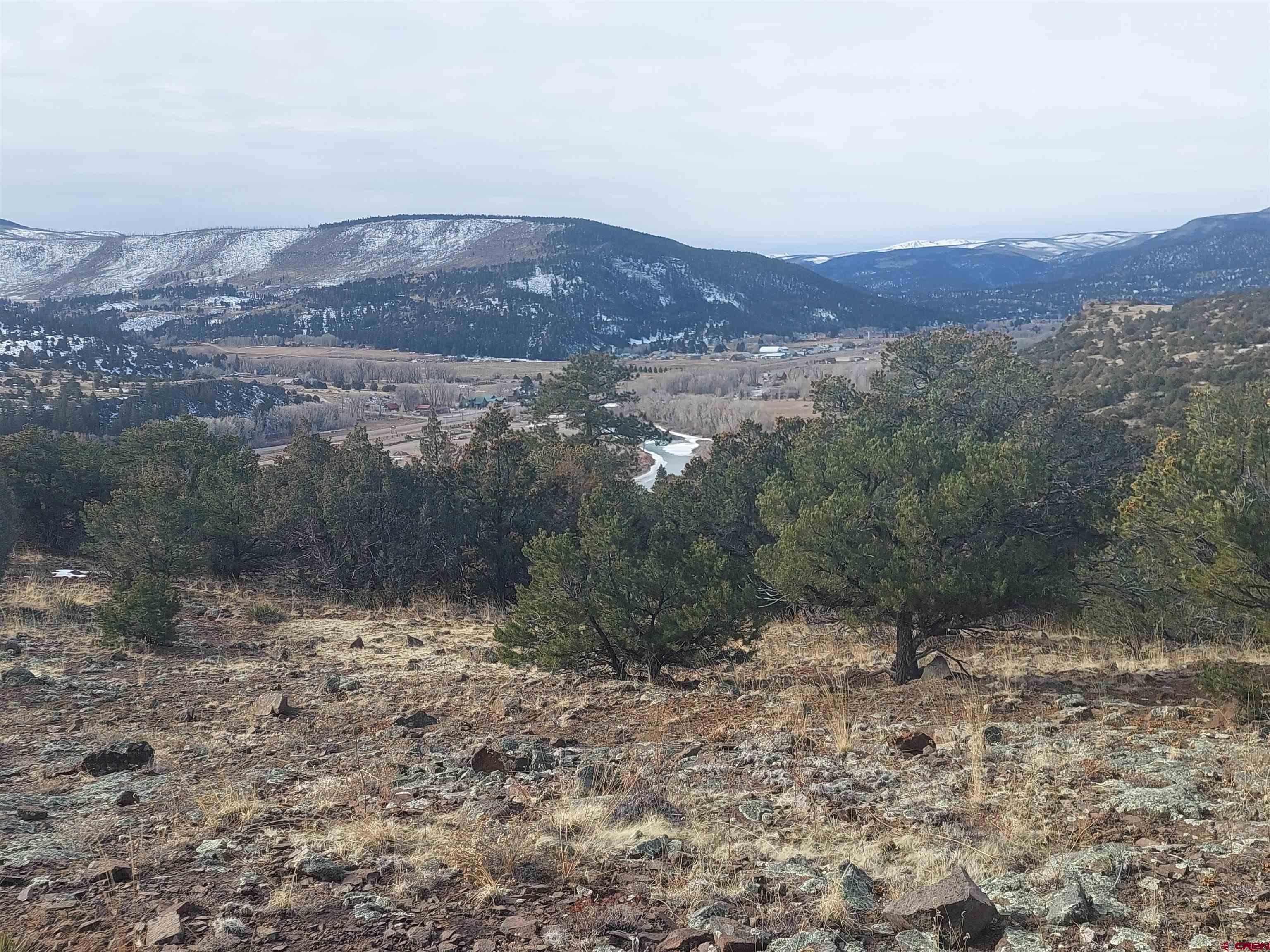 119 Cactus Road South Fork, CO 81154 - Photo 2 of 7 a view of a dry yard with mountains in the background