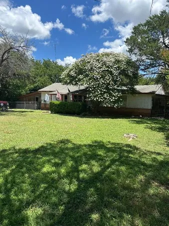 a view of a pool with a yard
