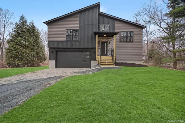 a front view of house with yard and green space
