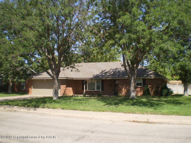 6202 Calumet Road Amarillo, TX 79106 - Photo 1 of 13 a front view of a house with a garden