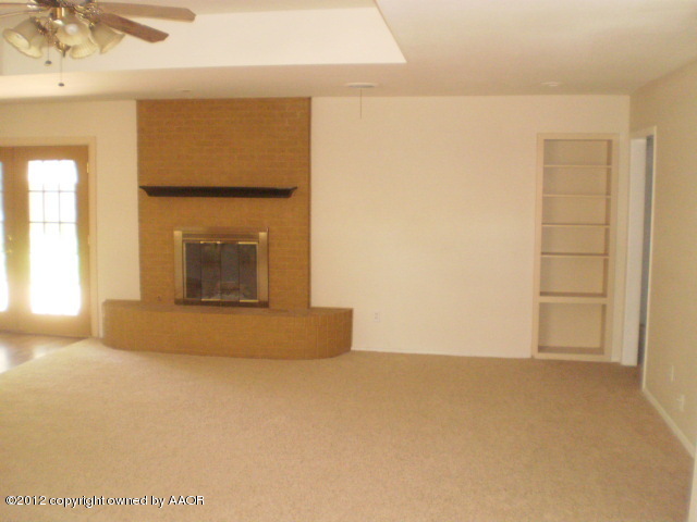 6202 Calumet Road Amarillo, TX 79106 - Photo 2 of 13 a view of an empty room with a fireplace