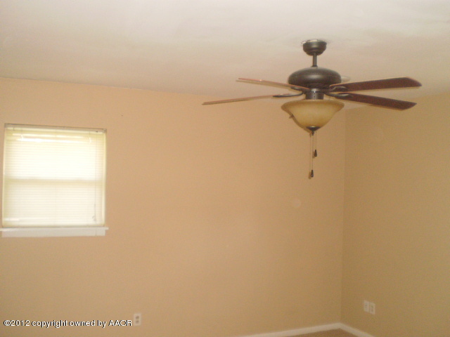 6202 Calumet Road Amarillo, TX 79106 - Photo 6 of 13 a view of a chandelier fan and wooden floor