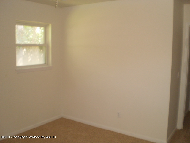 6202 Calumet Road Amarillo, TX 79106 - Photo 8 of 13 a view of an empty room with a window
