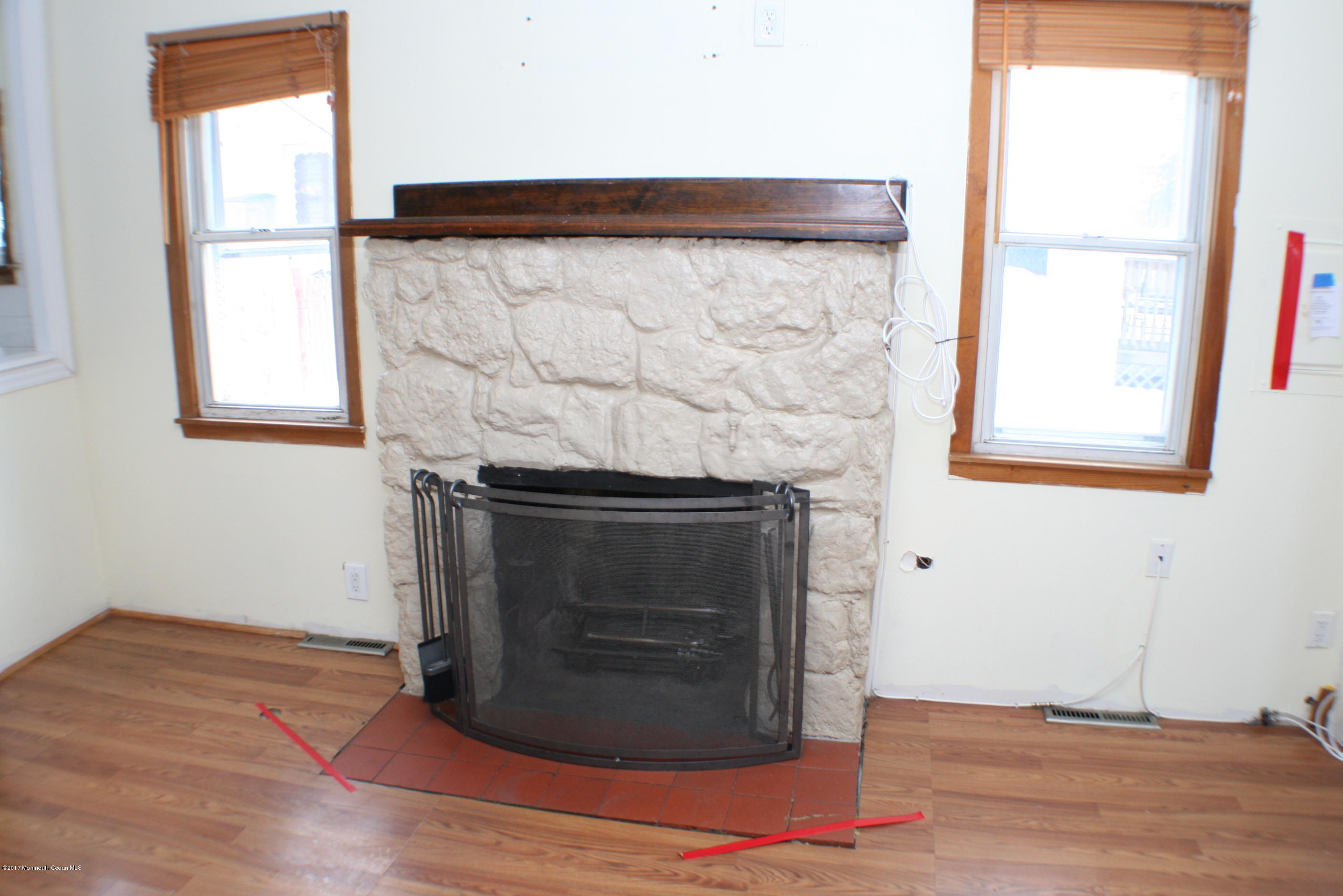 73 Breton Road Brick, NJ 08723 - Photo 29 of 40 a room with wooden floor and a fireplace