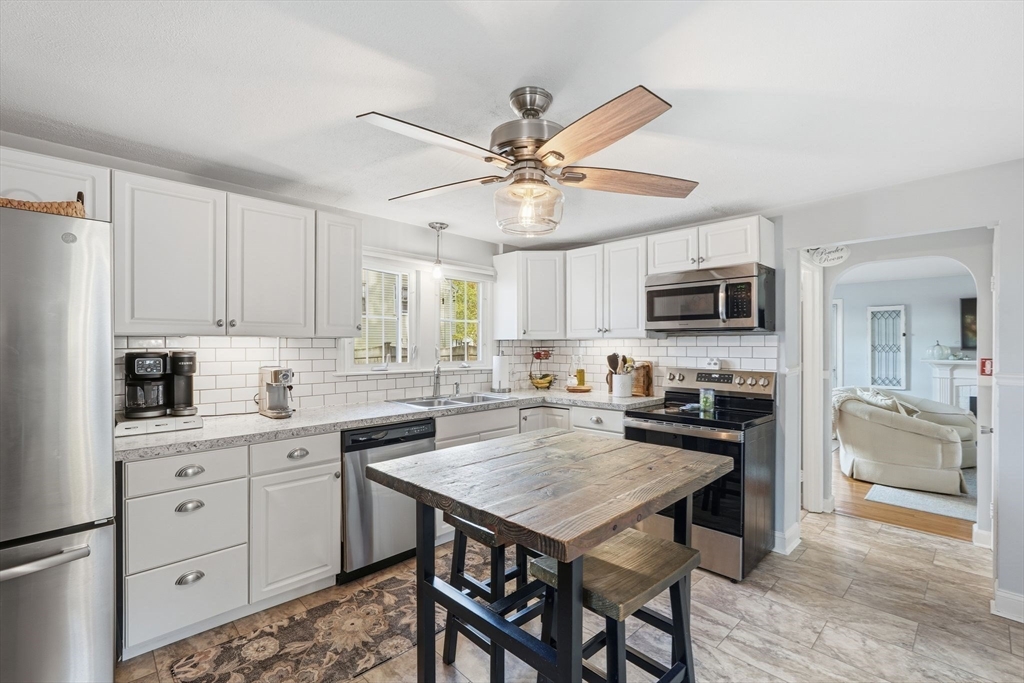 42 Redstone Drive Springfield, MA 01118 - Photo 11 of 37 a kitchen with a stove a sink and a refrigerator