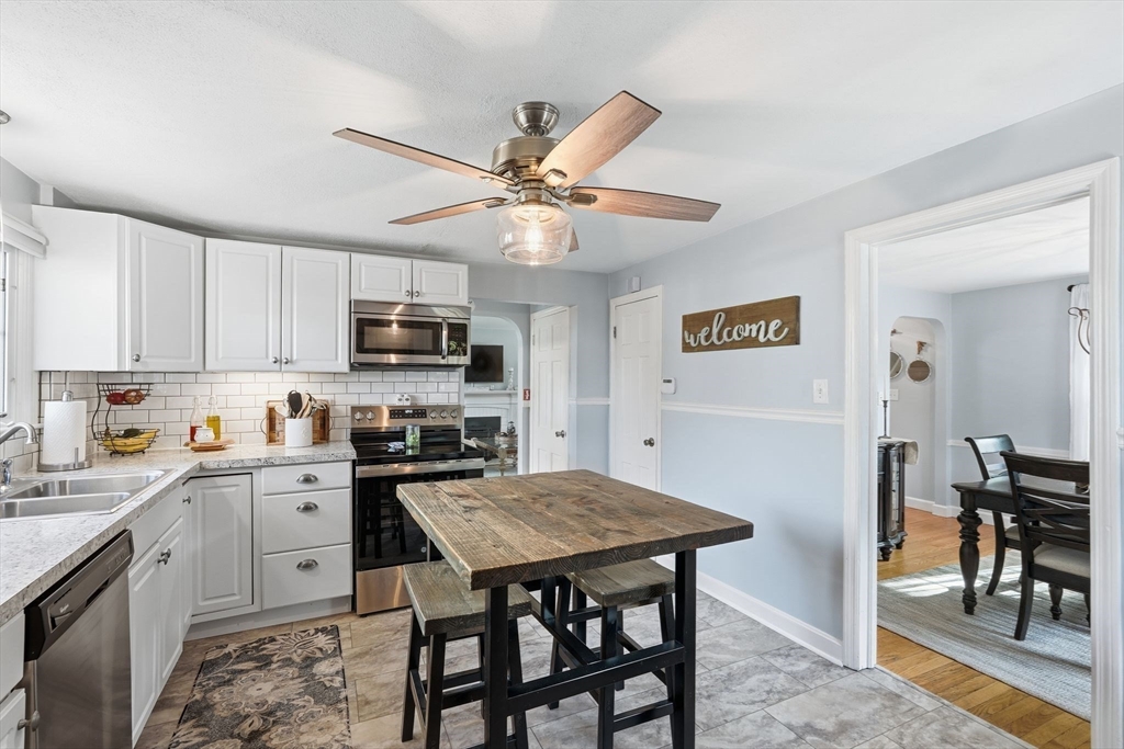 42 Redstone Drive Springfield, MA 01118 - Photo 14 of 37 a kitchen with a dining table and chairs