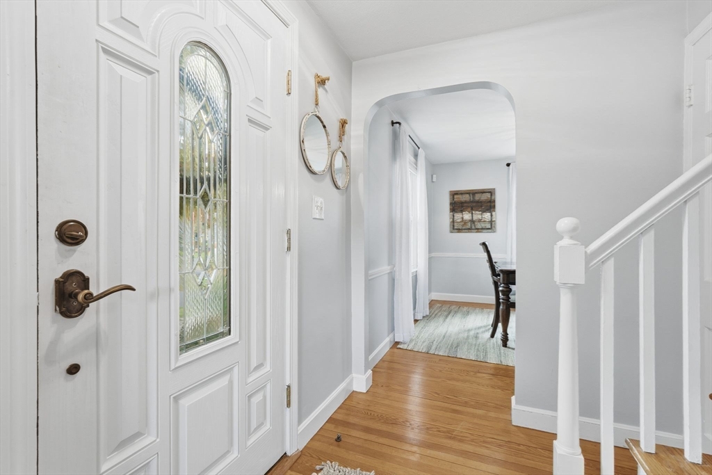 42 Redstone Drive Springfield, MA 01118 - Photo 17 of 37 a view of a hallway to a livingroom with wooden floor and staircase