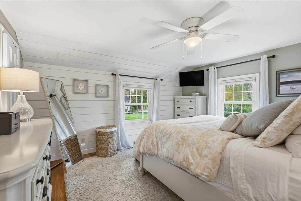 42 Redstone Drive Springfield, MA 01118 - Photo 20 of 37 a bedroom with a large bed and a flat tv screen on dresser