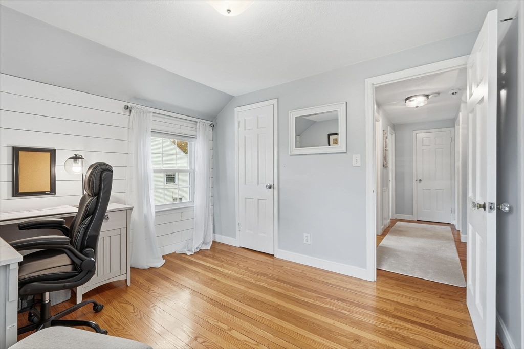 42 Redstone Drive Springfield, MA 01118 - Photo 22 of 37 a view of a workspace with furniture and wooden floor