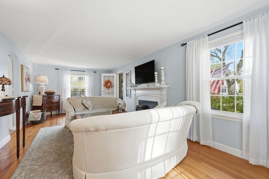 42 Redstone Drive Springfield, MA 01118 - Photo 5 of 37 a living room with furniture a flat screen tv and a window