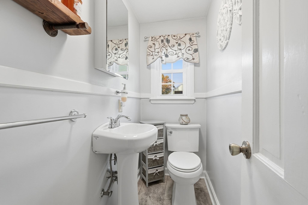 42 Redstone Drive Springfield, MA 01118 - Photo 10 of 37 a bathroom with a sink mirror and toilet