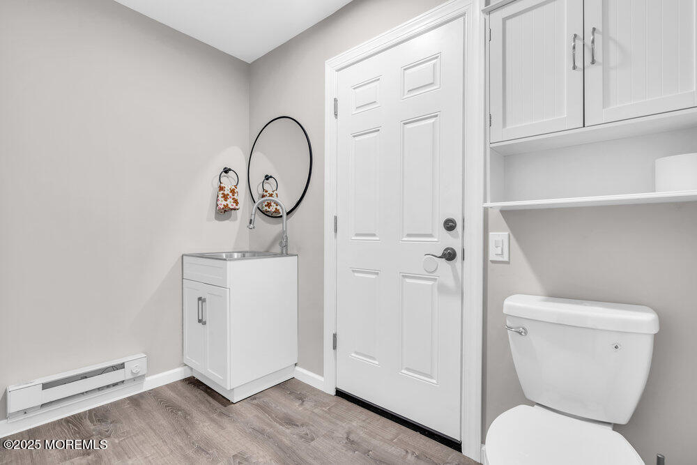 69 D Sunset Road, Unit 60 Whiting, NJ 08759 - Photo 14 of 19 a bathroom with a toilet a sink and a window
