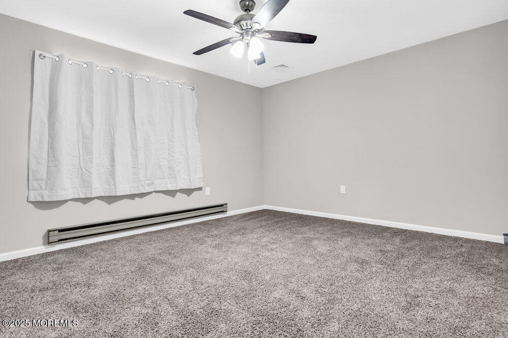 69 D Sunset Road, Unit 60 Whiting, NJ 08759 - Photo 17 of 19 a view of an empty room with a window