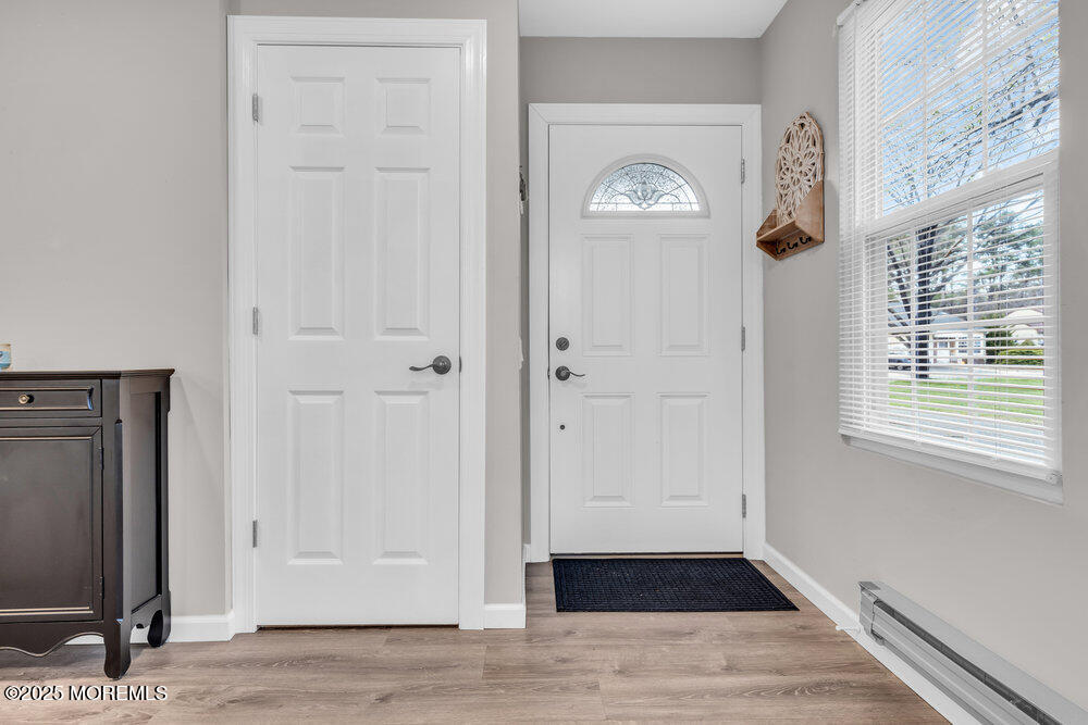 69 D Sunset Road, Unit 60 Whiting, NJ 08759 - Photo 3 of 19 a view of a hallway with wooden floor and a window
