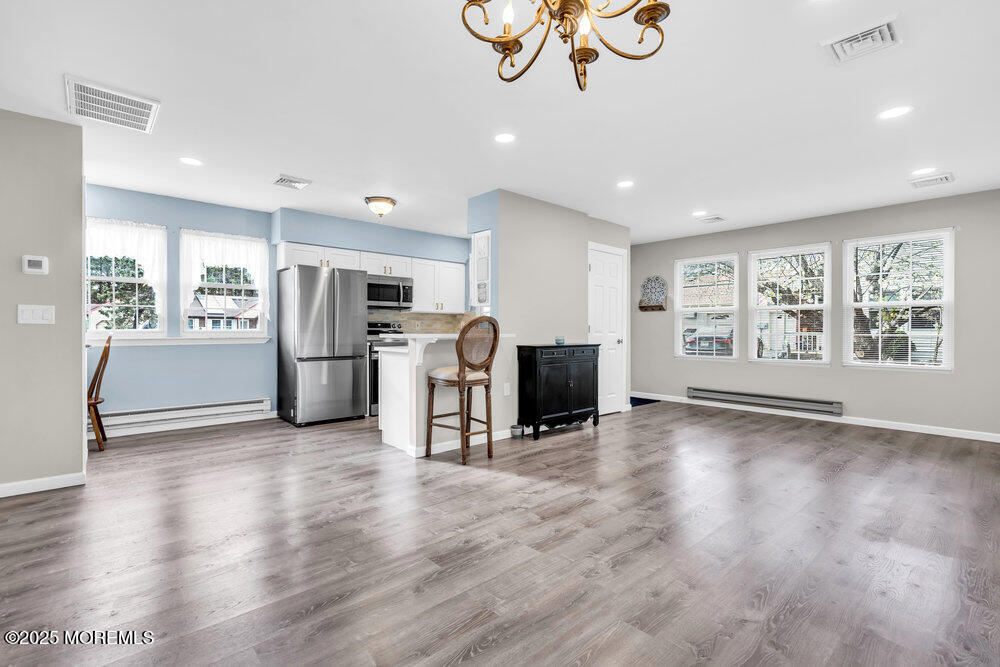 69 D Sunset Road, Unit 60 Whiting, NJ 08759 - Photo 6 of 19 a view of a livingroom with furniture a flat screen tv and refrigerator