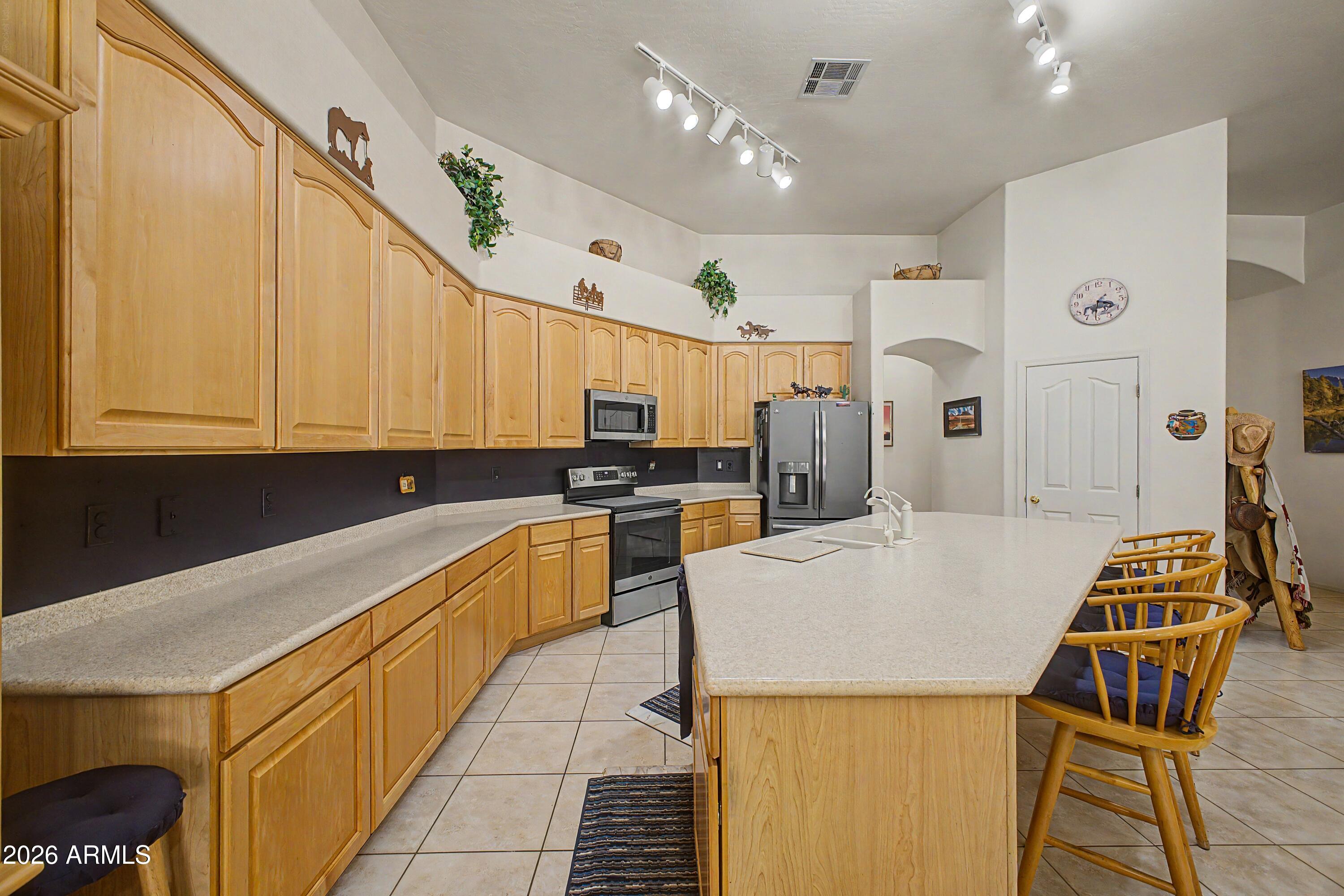 433 West Desert Avenue Gilbert, AZ 85233 - Photo 6 of 23 a large kitchen with a table and chairs