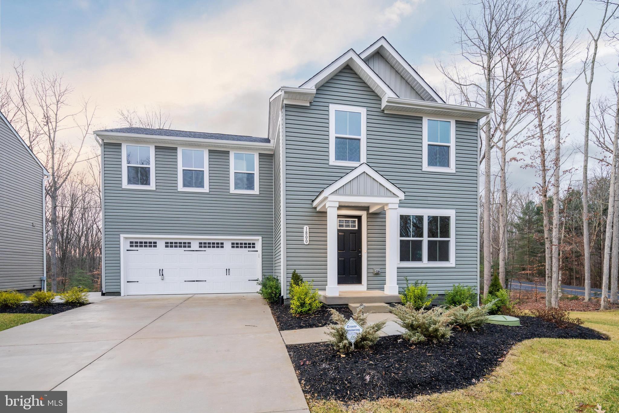 1800 Glenmere Road Stafford, VA 22554 - Photo 2 of 8 a front view of a house with a yard and garage