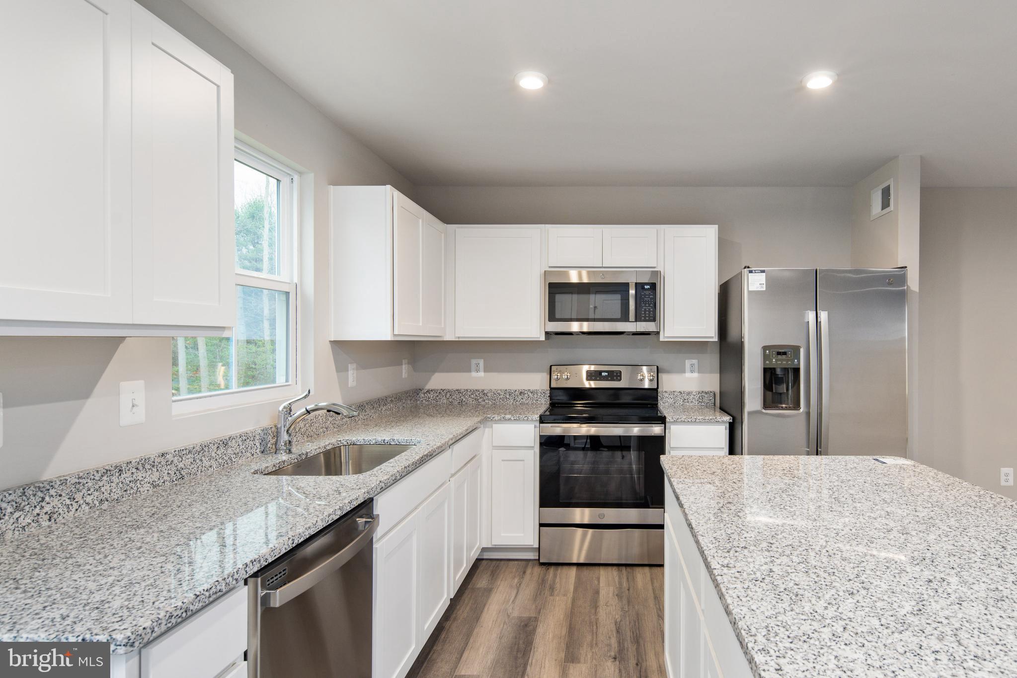 1800 Glenmere Road Stafford, VA 22554 - Photo 4 of 8 a kitchen with a sink stove top oven and refrigerator