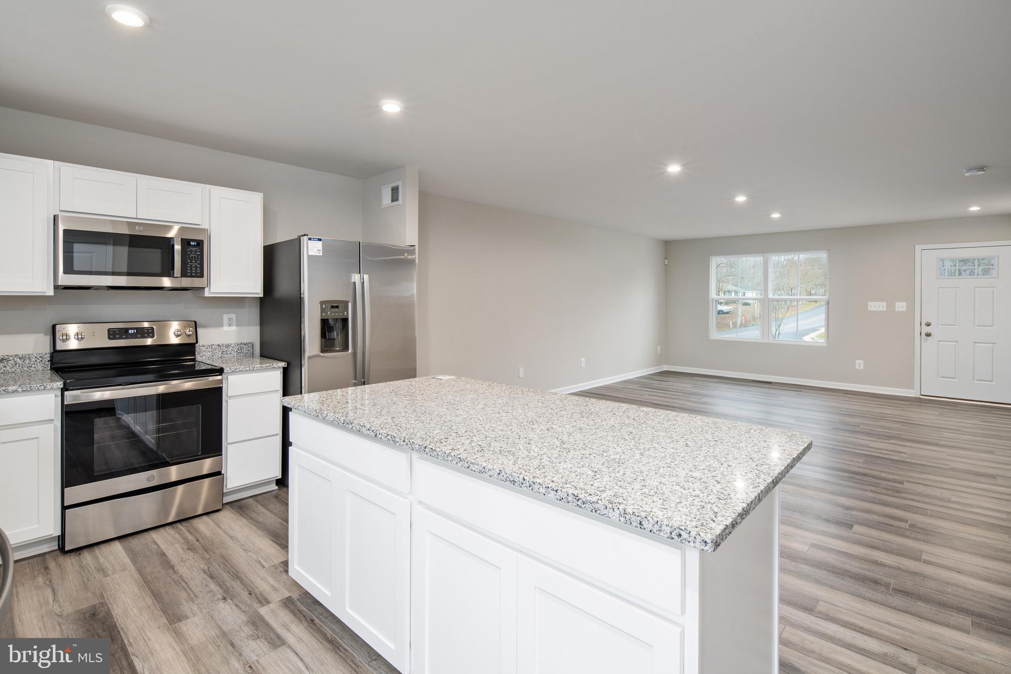 1800 Glenmere Road Stafford, VA 22554 - Photo 6 of 8 a kitchen with granite countertop kitchen island wooden cabinets and stainless steel appliances