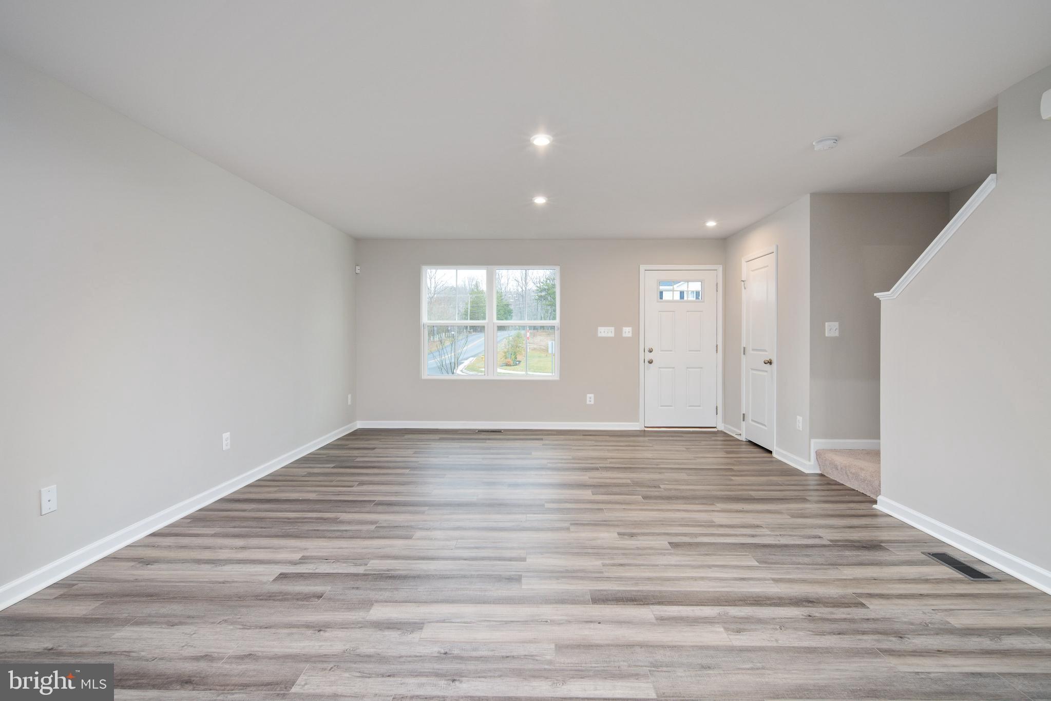 1800 Glenmere Road Stafford, VA 22554 - Photo 8 of 8 a view of an empty room with wooden floor and a window