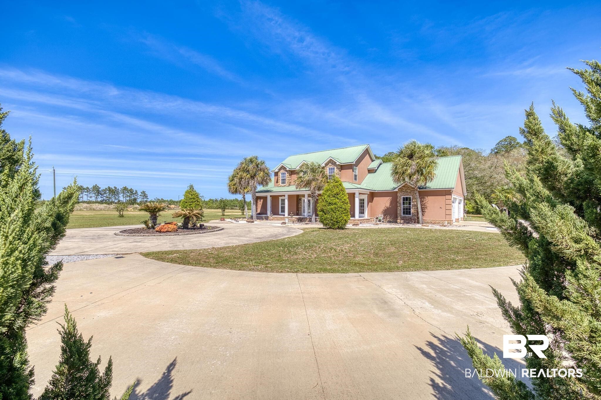 32875 Faircloth Road Lillian, AL 36549 - Photo 8 of 85 View of front of property with a porch, a metal roof, a front yard, and curved driveway