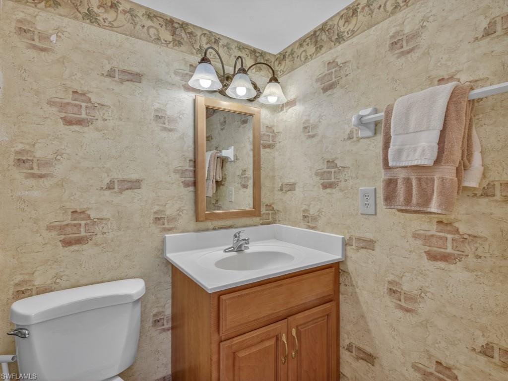 766 Central Avenue, Unit 101 Naples, FL 34102 - Photo 12 of 19 a bathroom with a sink a toilet and shower