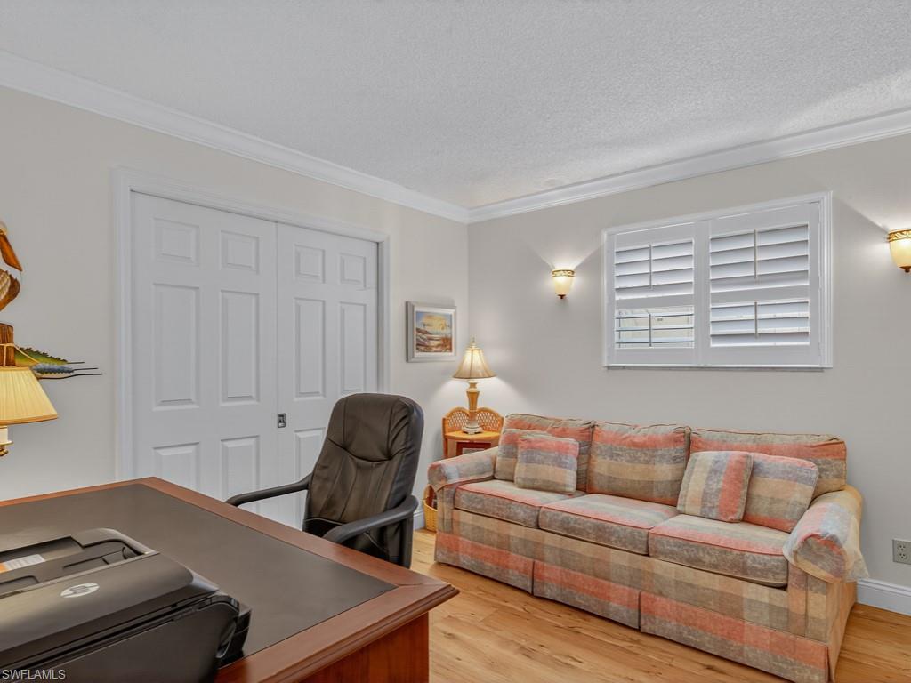 766 Central Avenue, Unit 101 Naples, FL 34102 - Photo 13 of 19 a living room with furniture and a window