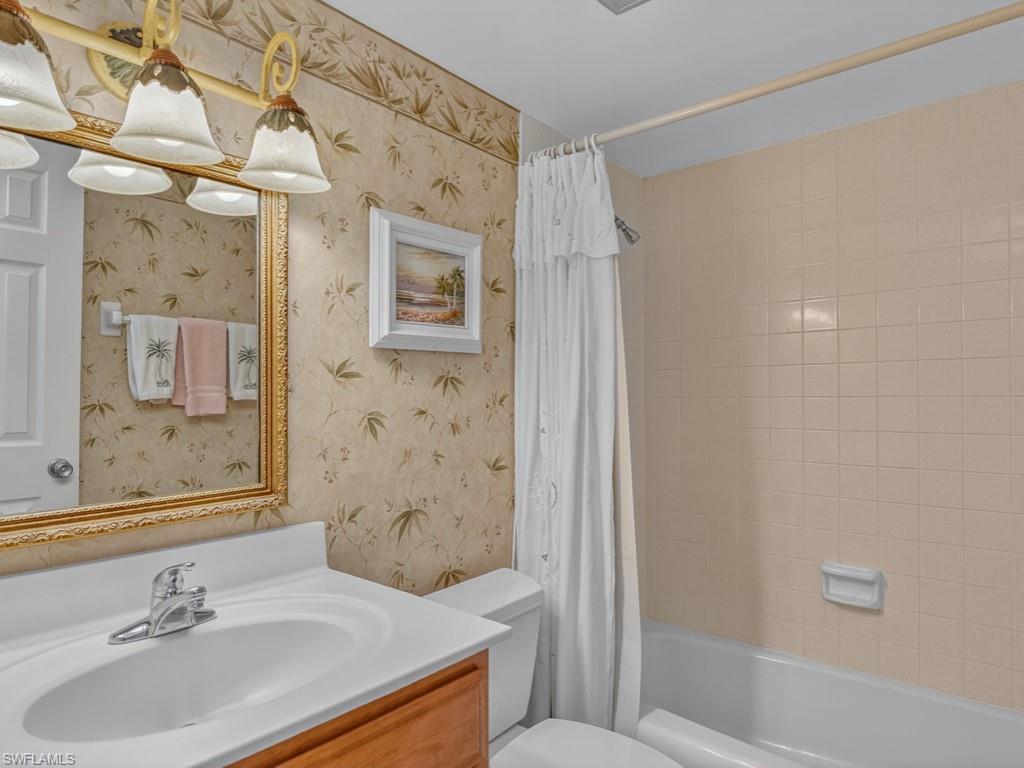766 Central Avenue, Unit 101 Naples, FL 34102 - Photo 14 of 19 a bathroom with a sink toilet and shower