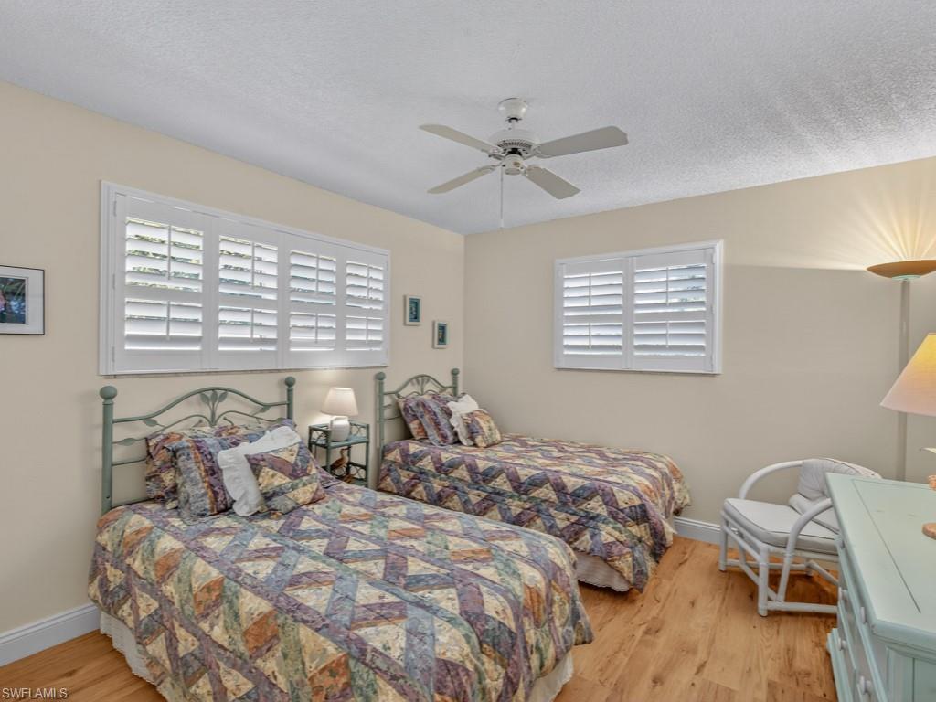 766 Central Avenue, Unit 101 Naples, FL 34102 - Photo 15 of 19 a bedroom with a bed and a window